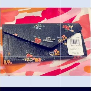 Brand new coach wallet. Never used. Black with wild print